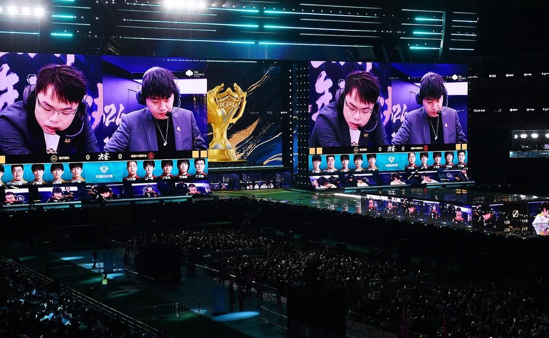 Packed esports arena during the KPL Grand Final featuring AG vs Wolves, with players on stage, massive LED screens, and the championship trophy displayed.