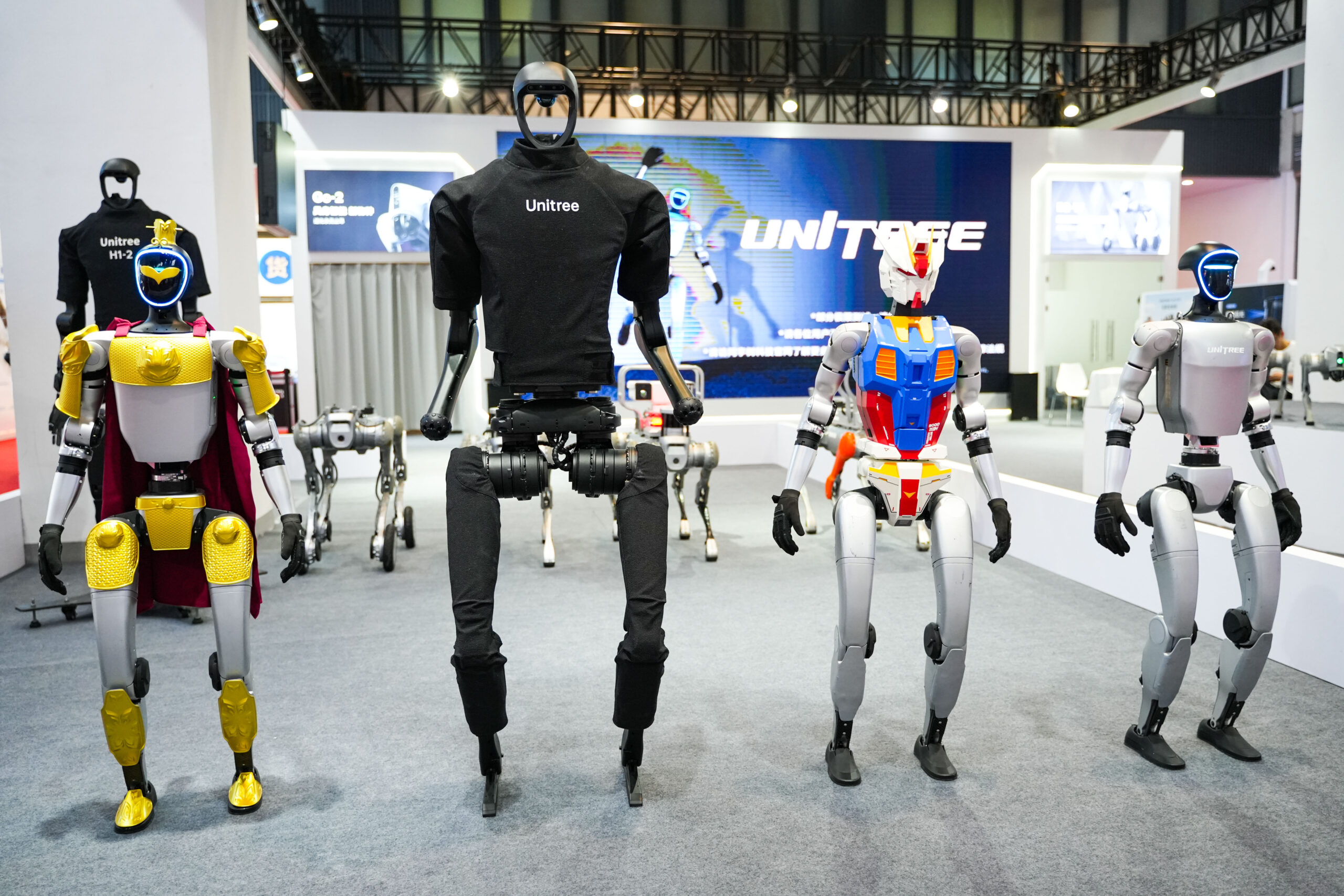Unitree humanoid robots displayed at a tech exhibition, showcasing advanced robotics innovation, AI-driven humanoid design, and China’s growing role in next-generation automation.