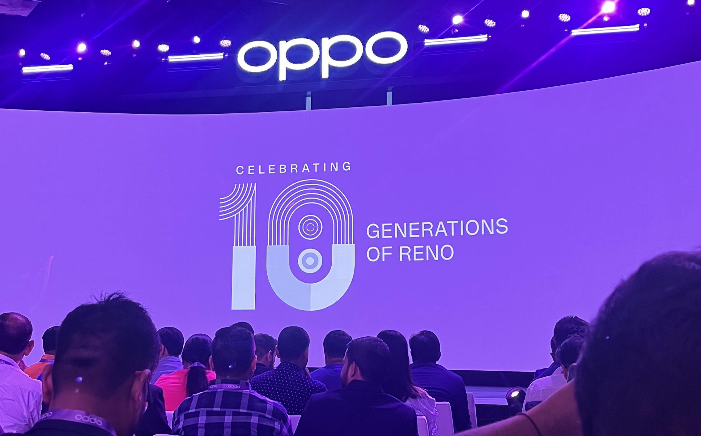 OPPO stage event celebrating 10 generations of the Reno smartphone series, with a large purple backdrop, OPPO logo, and audience attending a brand launch presentation.