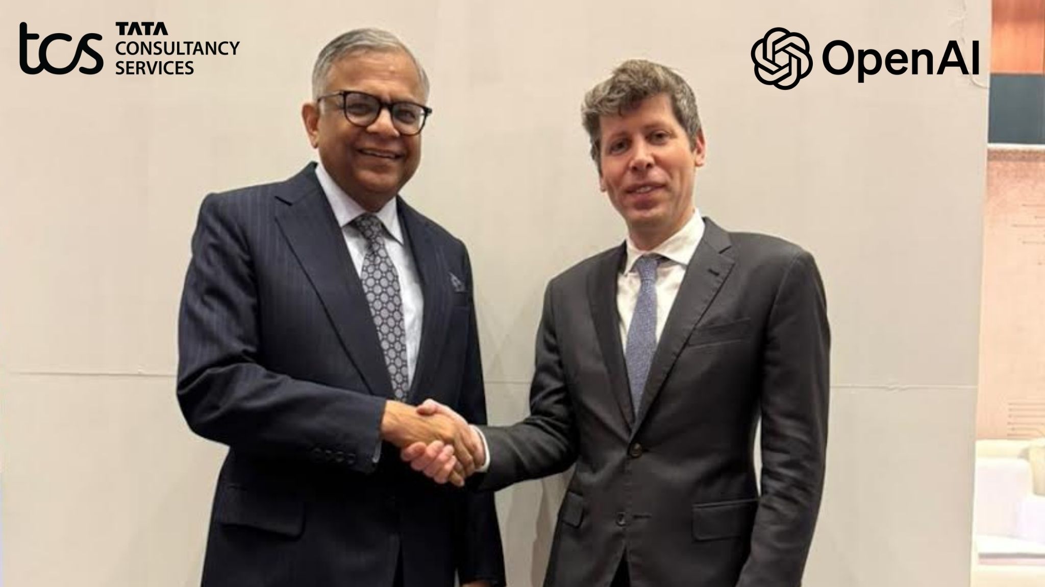 TCS and OpenAI executives shake hands during partnership meeting, highlighting AI collaboration between Tata Consultancy Services and OpenAI.