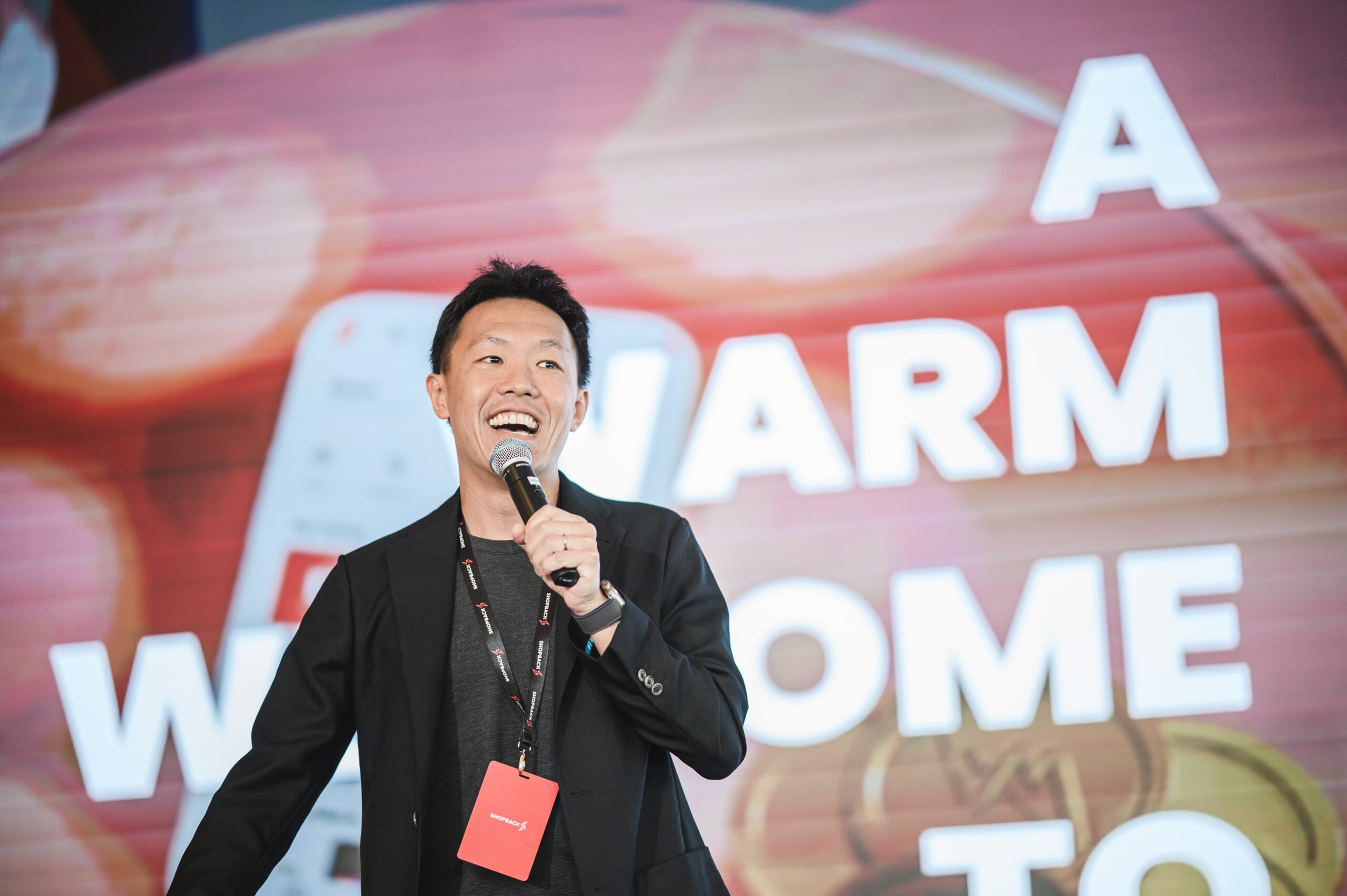 Henry Chan, founder of ShopBack, speaking on stage at a company event