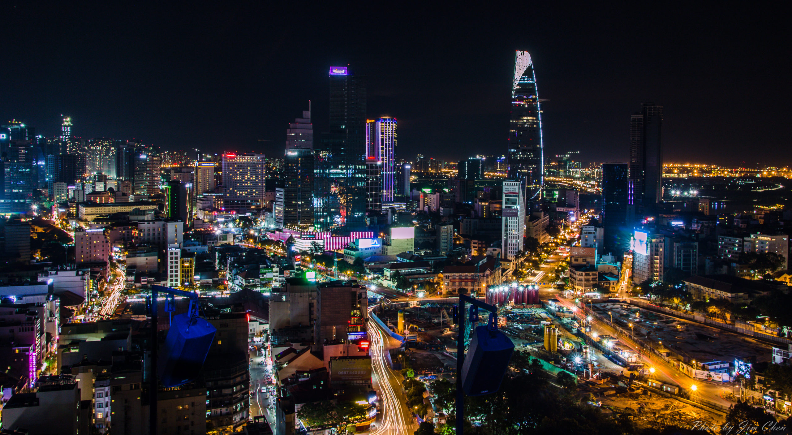 Night skyline of Ho Chi Minh City, Vietnam, featuring Bitexco Financial Tower and illuminated urban landscape.