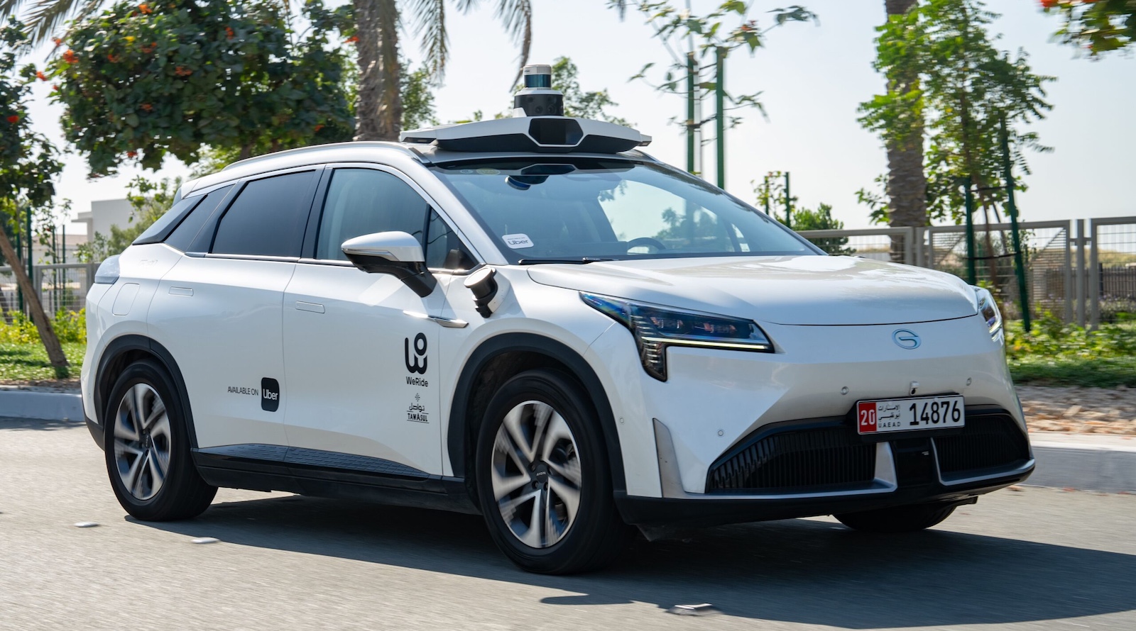 WeRide autonomous vehicle operating on UAE roads with Uber and TAMASUL branding, showcasing self-driving sensor technology and smart urban mobility innovation.