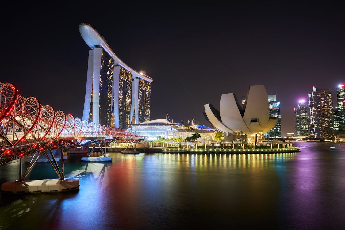 Night view of Marina Bay Sands, ArtScience Museum, and Helix Bridge in Singapore.
