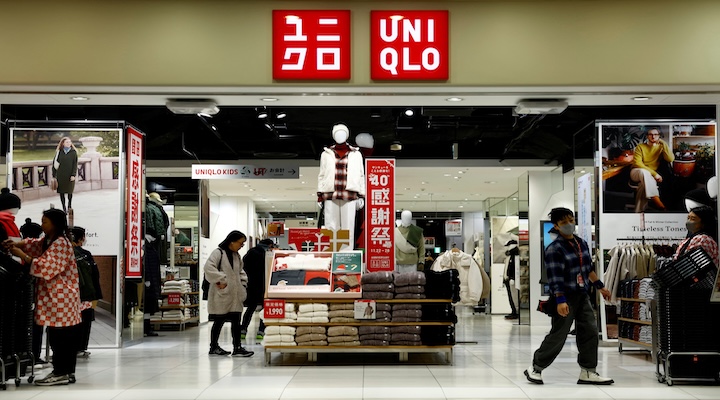 Front view of a UNIQLO retail store with customers shopping and winter clothing displays at the entrance.