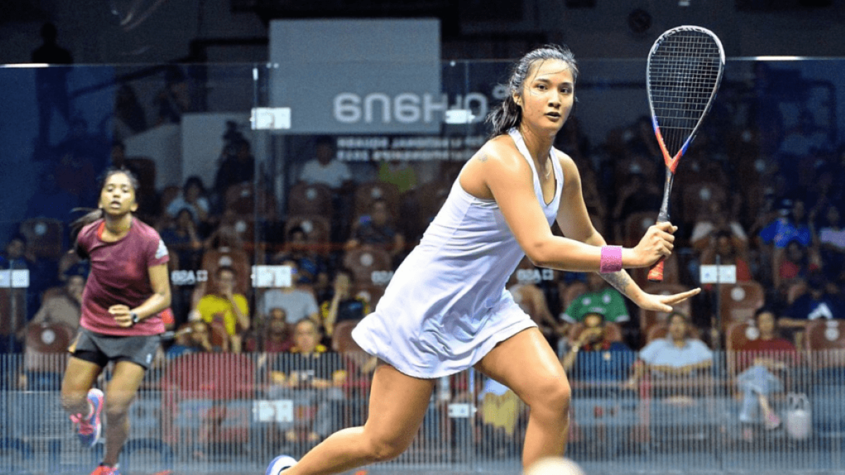 Rachel Arnold competing in a professional squash match during the Asian Squash Championships, showcasing athleticism and focus on court