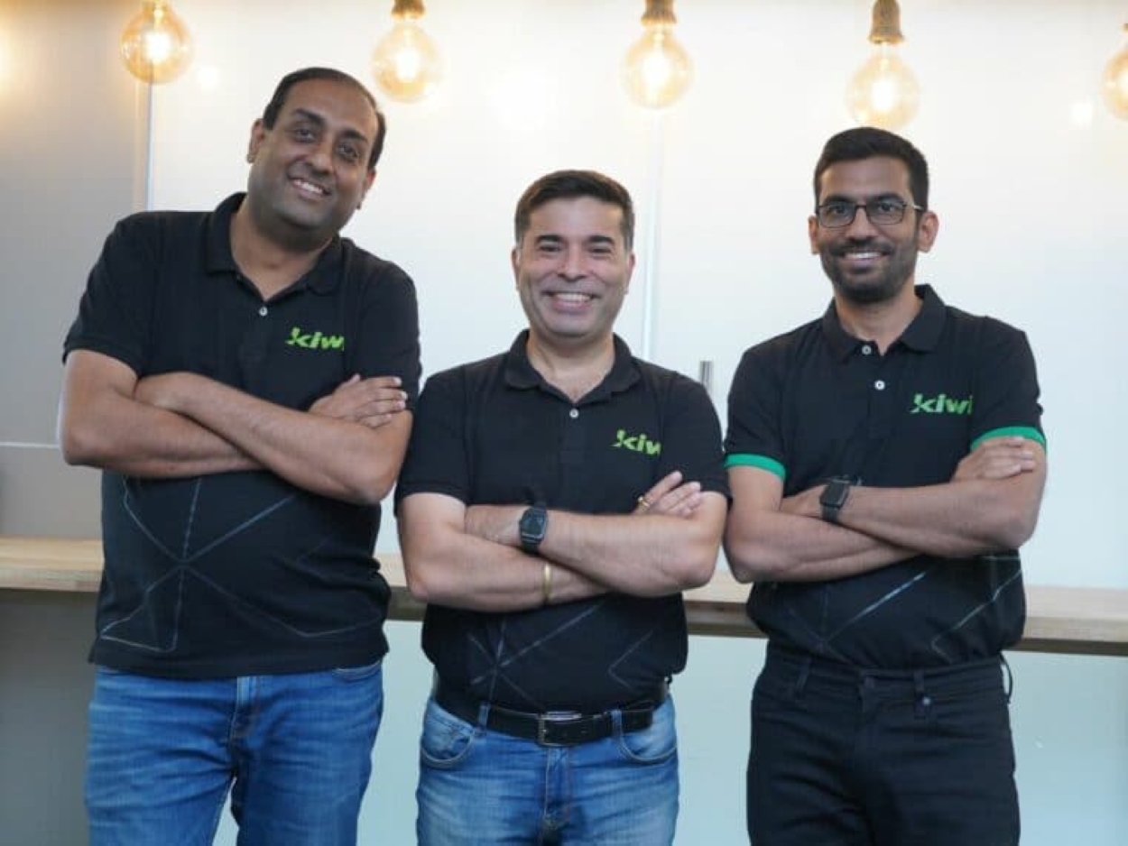 Kiwi founders posing together in company shirts, representing the Indian fintech startup driving innovation in credit cards and digital payments.