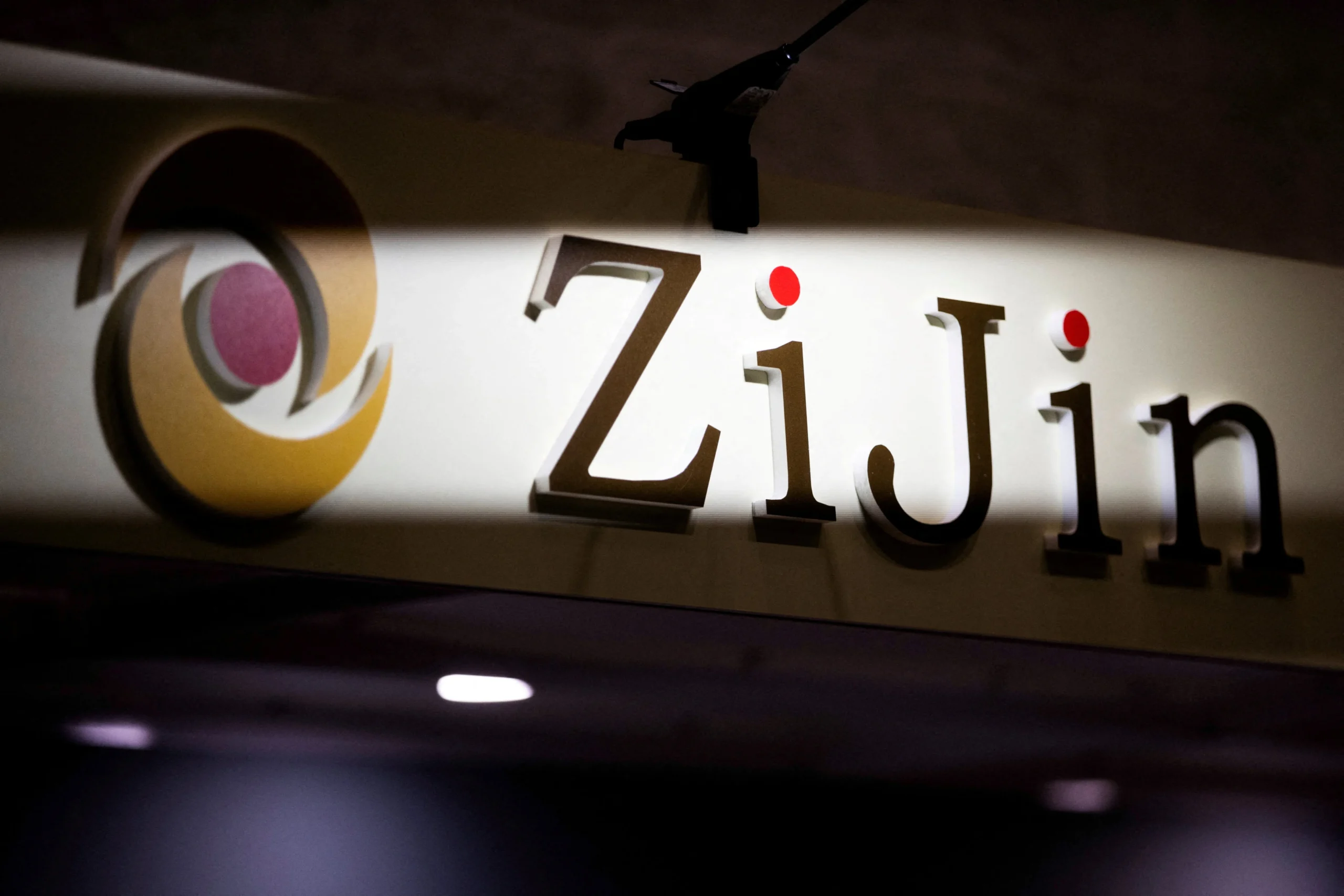 Zijin Mining Group company logo illuminated on a wall, representing one of China’s largest gold and copper producers.