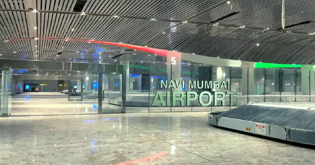 Interior view of Navi Mumbai International Airport showcasing modern design and baggage claim area.