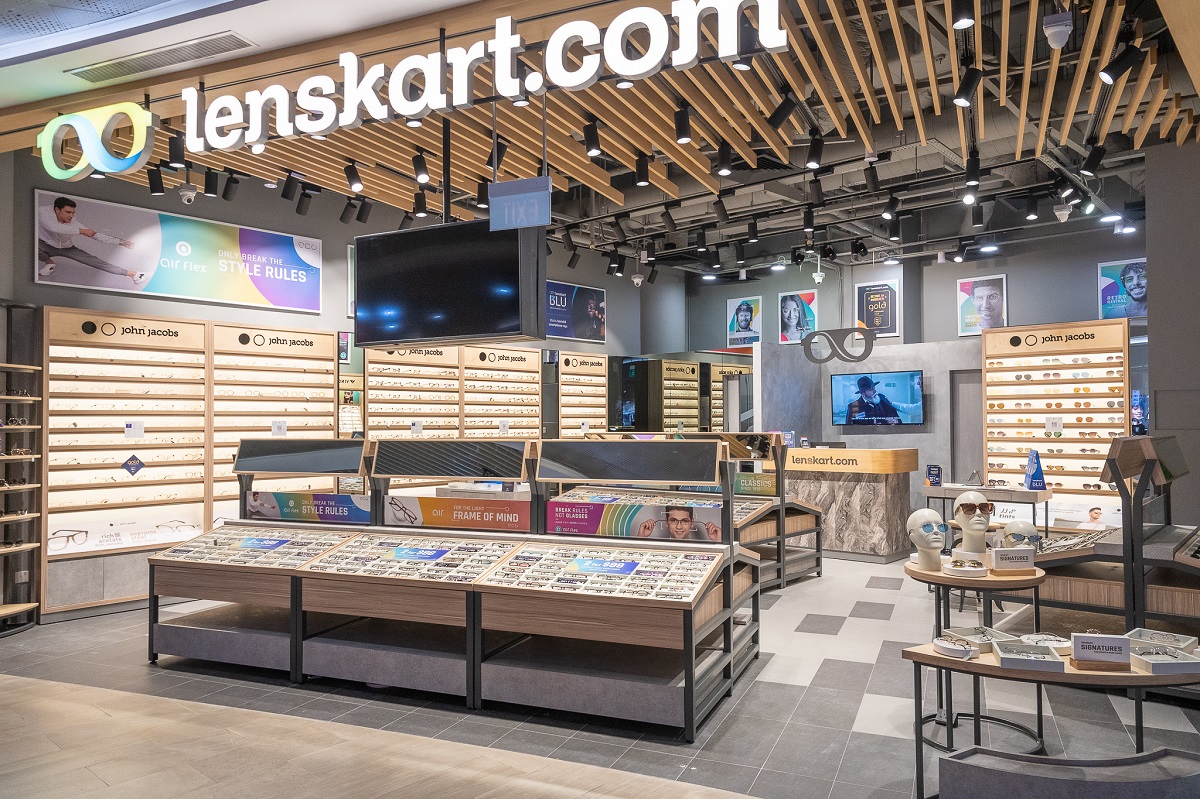 Interior of a modern Lenskart eyewear store showcasing stylish eyeglass frames, branded displays, and digital screens under bright retail lighting.