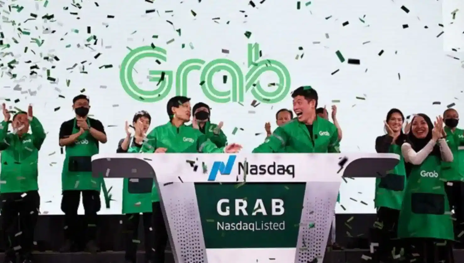 Grab executives and staff celebrate the company’s Nasdaq listing during its public market debut.