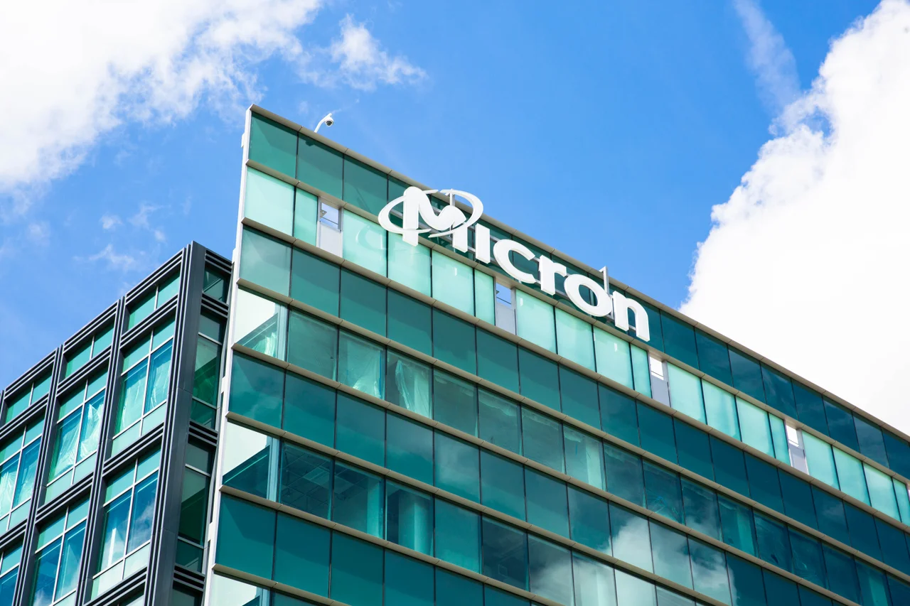 Micron Technology corporate office building with the Micron logo on a modern glass façade, representing semiconductor manufacturing, memory chip innovation, and global technology infrastructure.